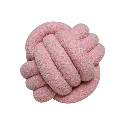 A braided knotted ball pillow