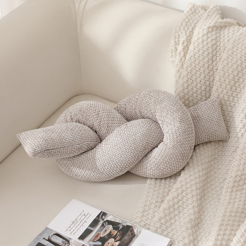 A knotted pillow throw pillow