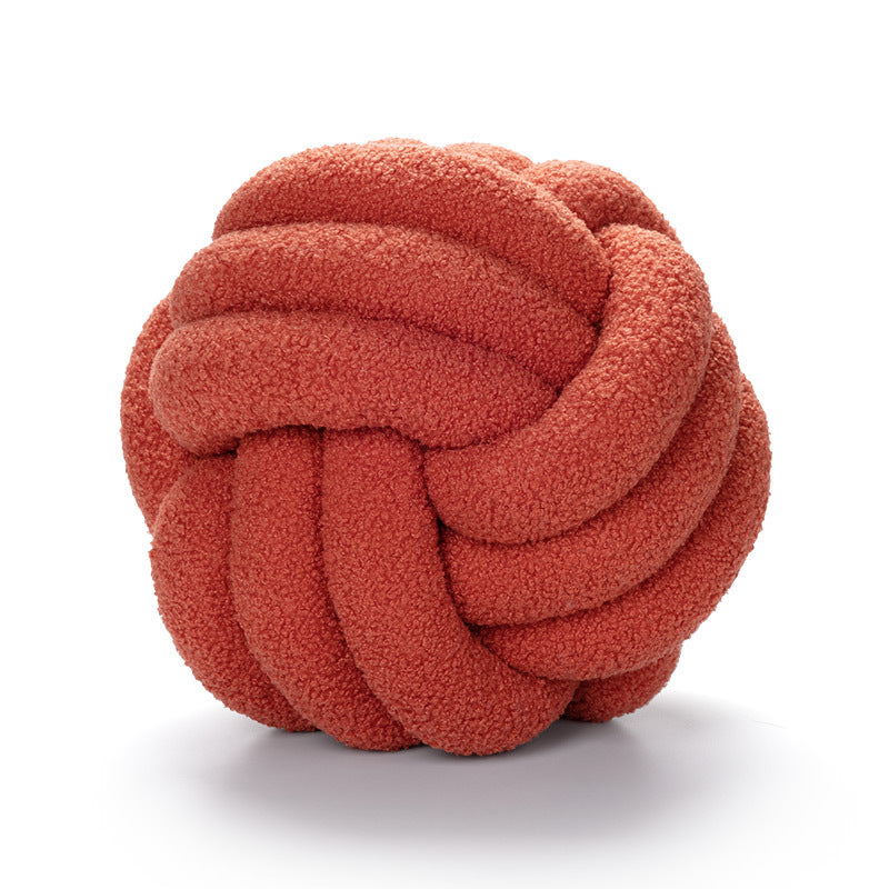 A braided knotted ball pillow