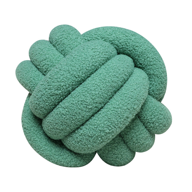 A braided knotted ball pillow