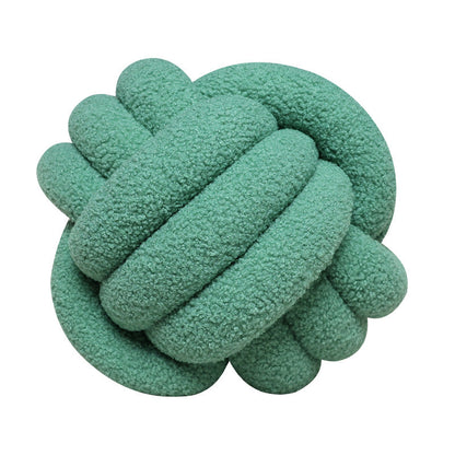 A braided knotted ball pillow