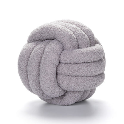 A braided knotted ball pillow