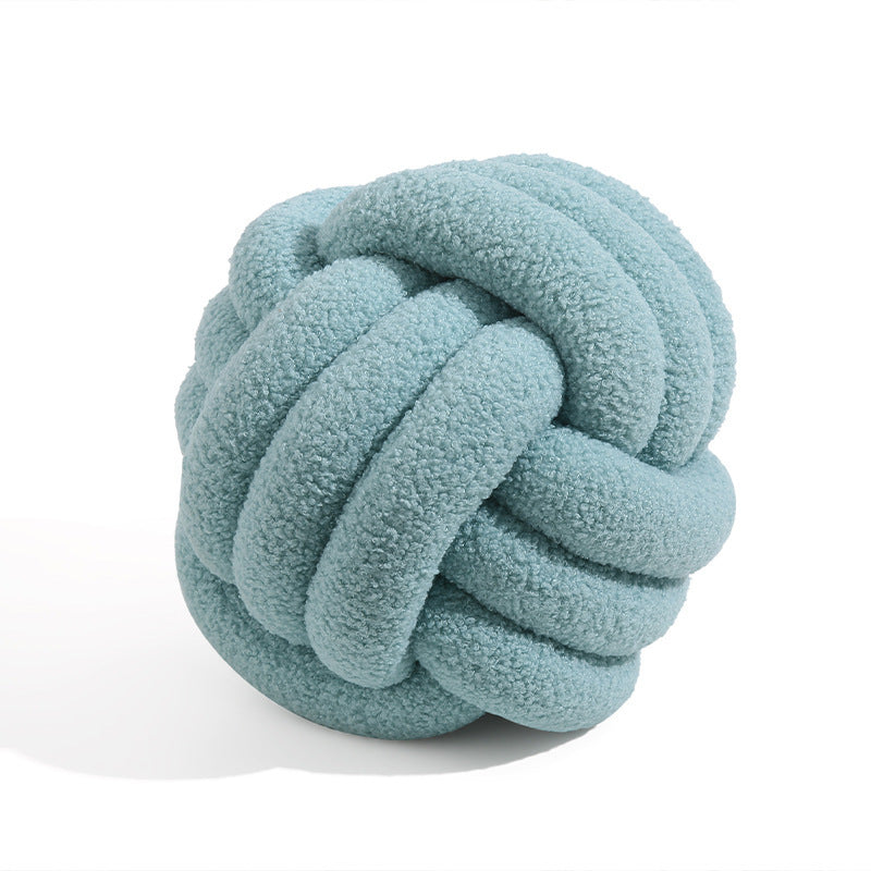 A braided knotted ball pillow