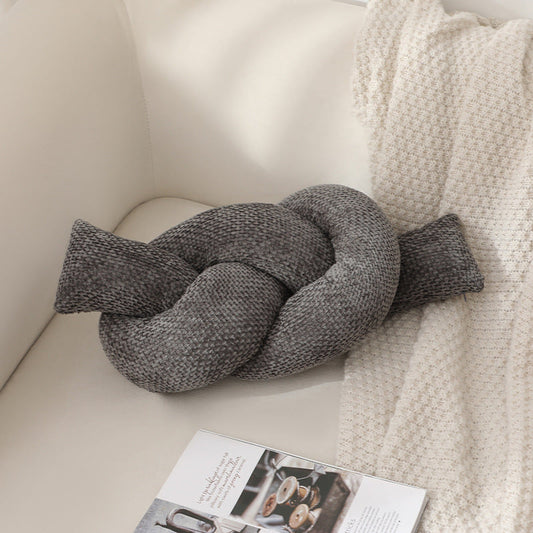 A knotted pillow throw pillow