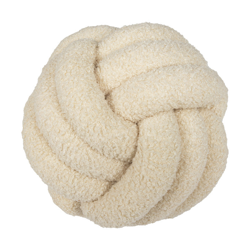 A braided knotted ball pillow