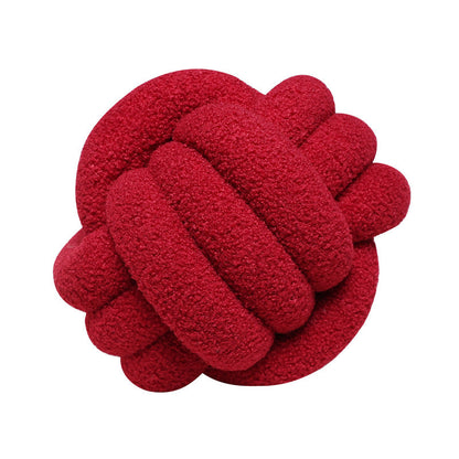 A braided knotted ball pillow