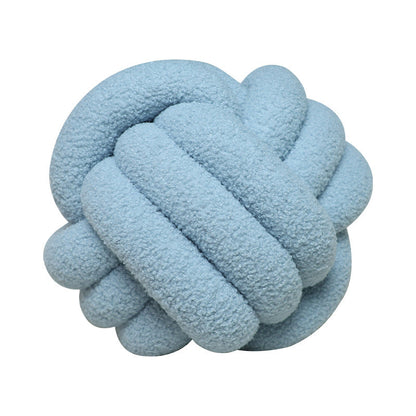 A braided knotted ball pillow