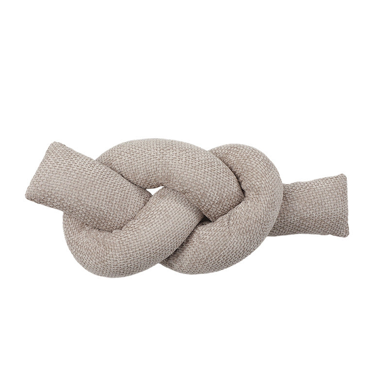 A knotted pillow throw pillow