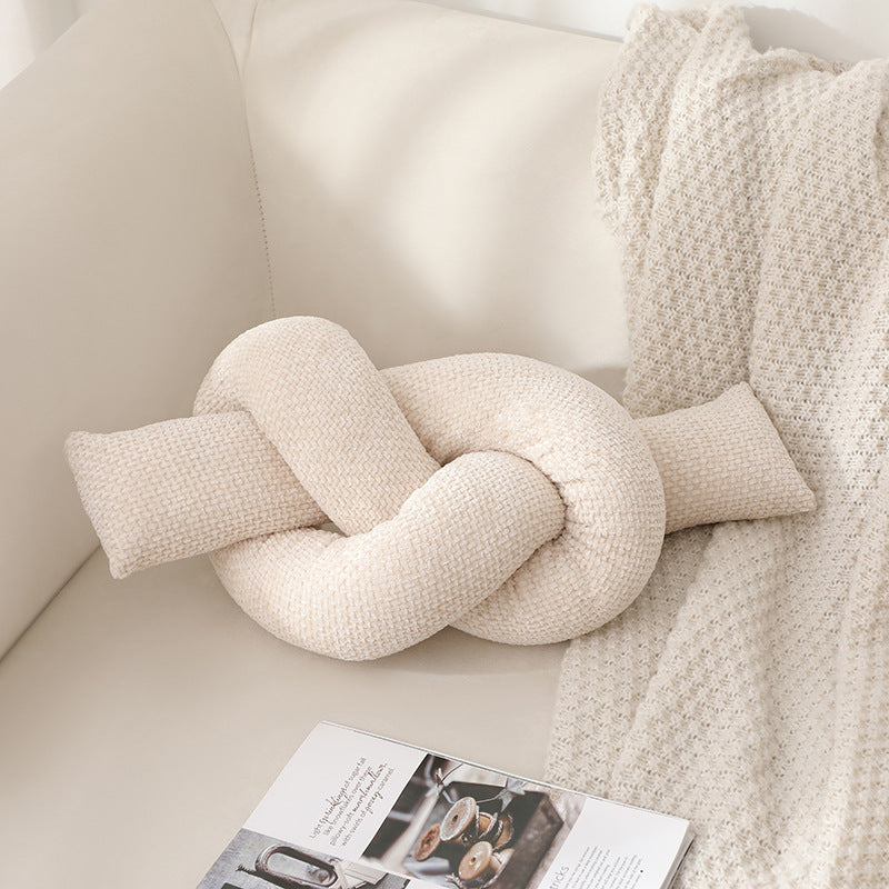A knotted pillow throw pillow