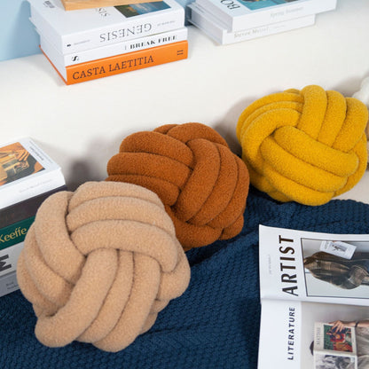 A braided knotted ball pillow