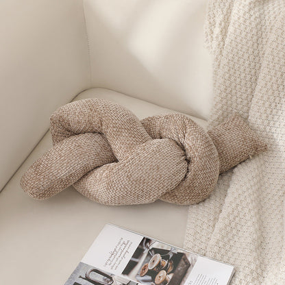 A knotted pillow throw pillow